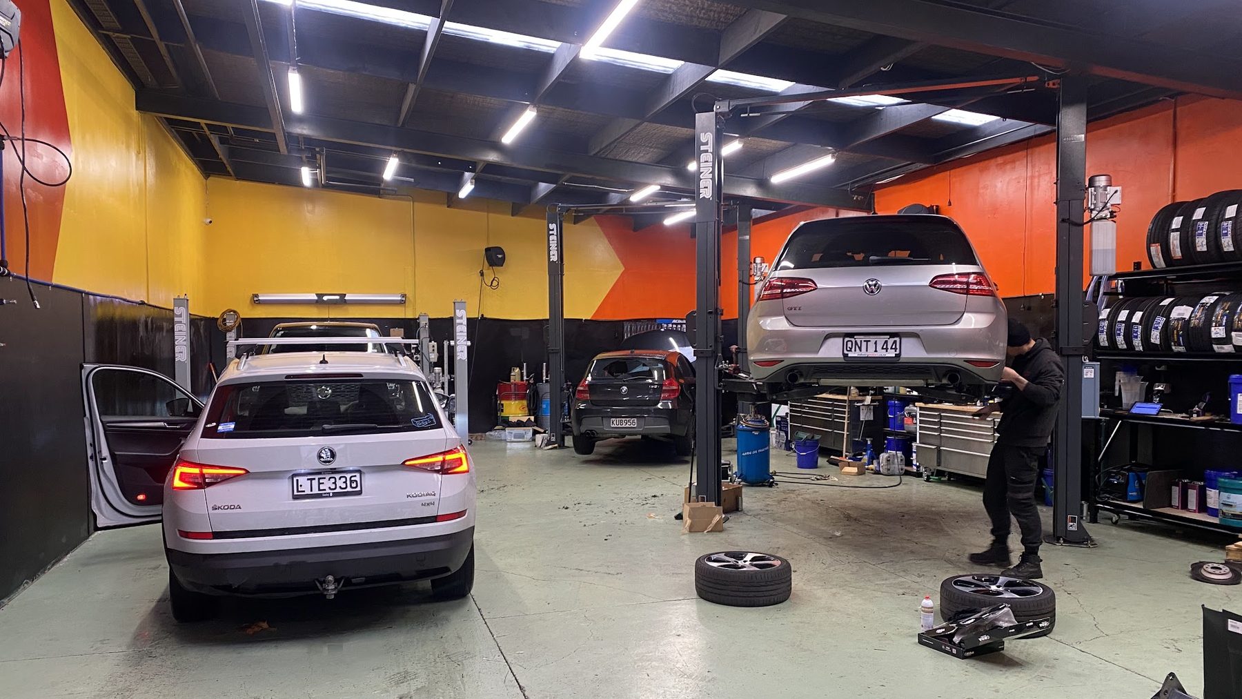 Inside a South End Motors workshop, a vehicle up on the hoist