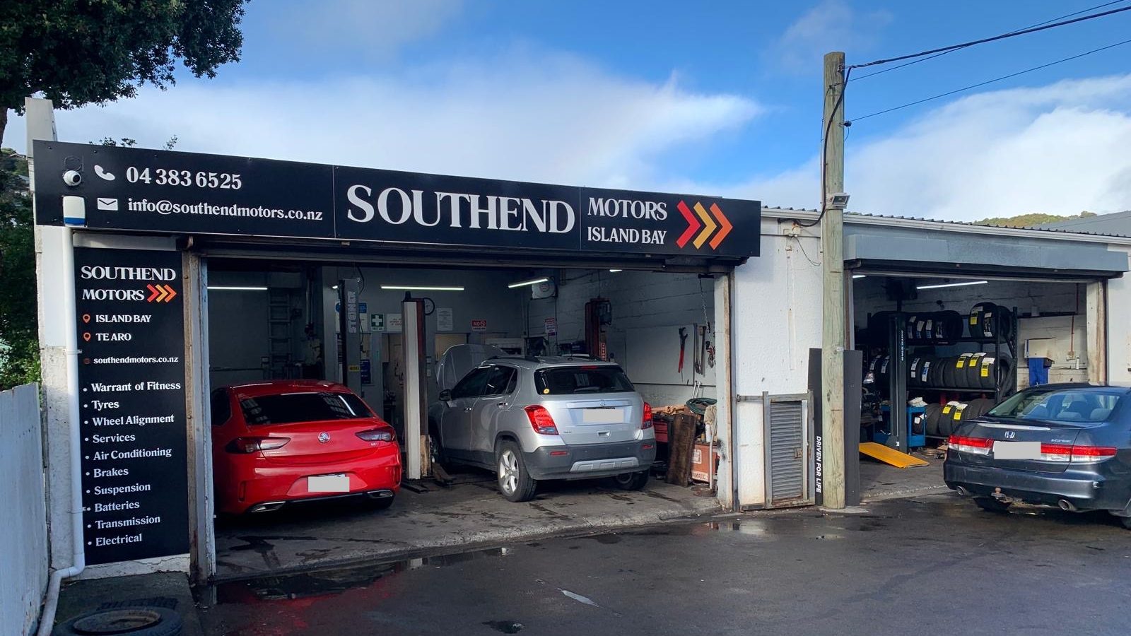 South End Motors Island Bay shopfront, with two cars parked in the open bays